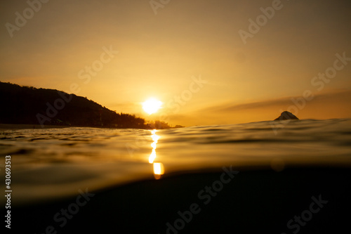 silhourtte of a person on the beach at sunrise photo