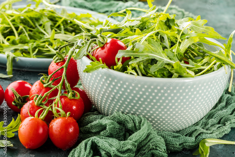 close-up view of fresh salad with tomatoes and arugula on table close-up view of fresh salad with tomatoes and arugula on table