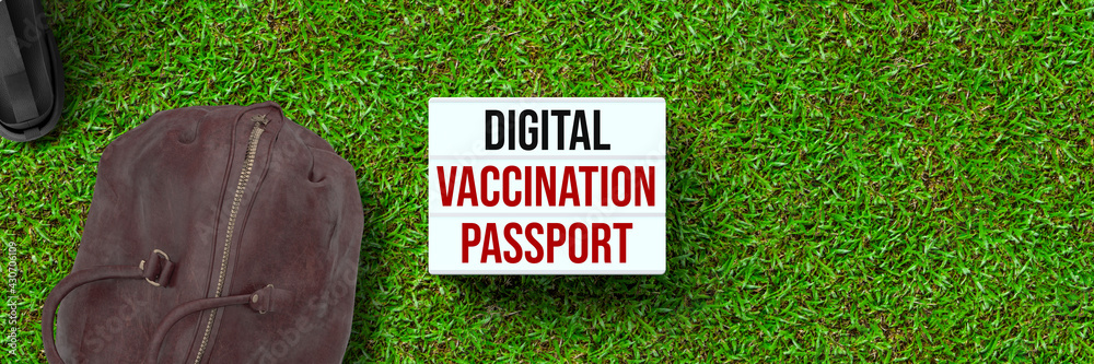 lightbox with message DIGITAL VACCINATION PASSPORT and a backpack on grass background