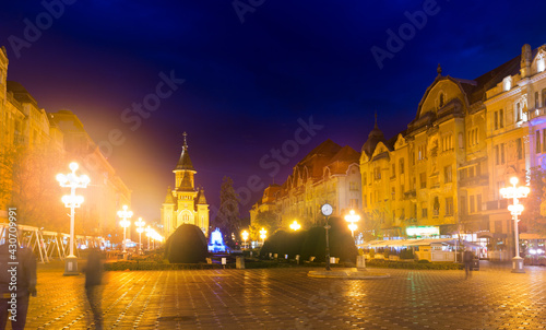 Illuminated Victoriei Square with Romanian Orthodox Metropolitan Cathedral at dusk, Romania