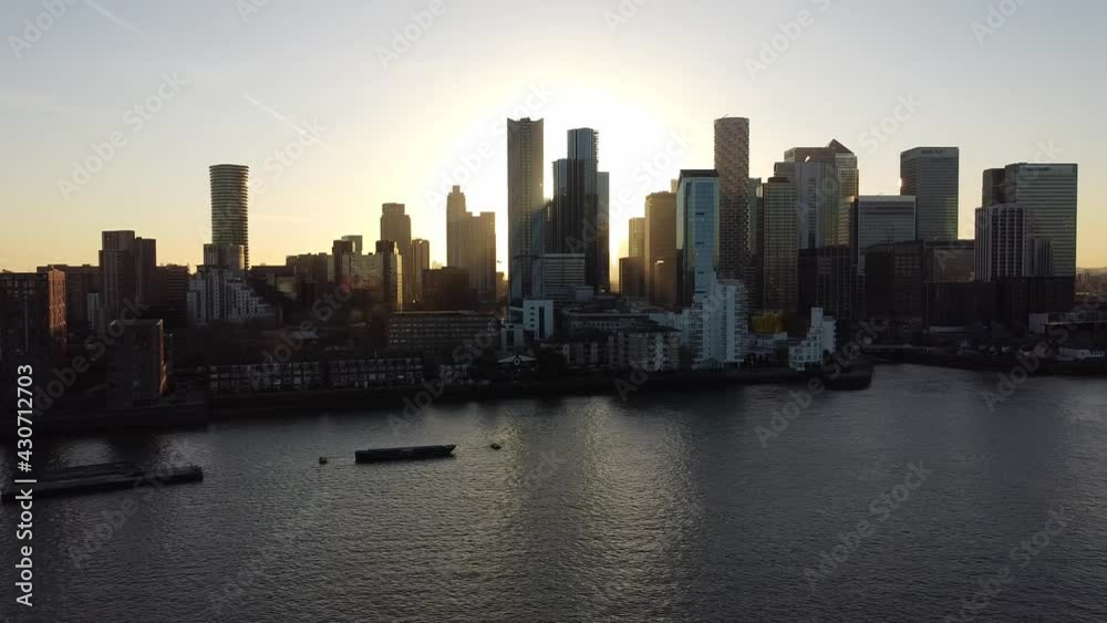 Aerial - Sunset over River Thames and Canary Wharf, London, UK, wide pan right Aerial - Sunset over River Thames and Canary Wharf, London, UK, wide pan right