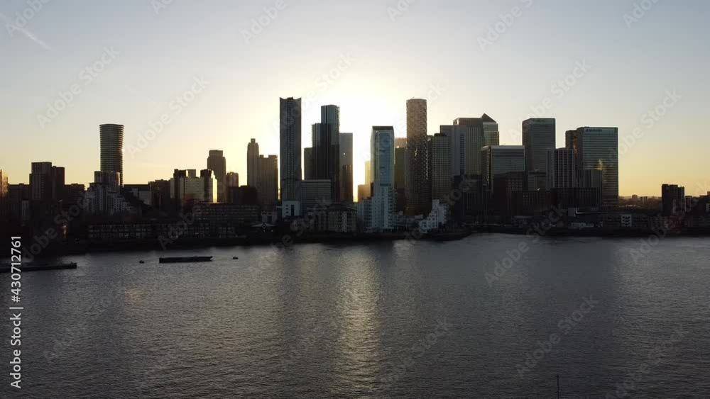 Aerial - Sunset on the River Thames and Canary Wharf, London, wide lowering shot Aerial - Sunset on the River Thames and Canary Wharf, London, wide lowering shot