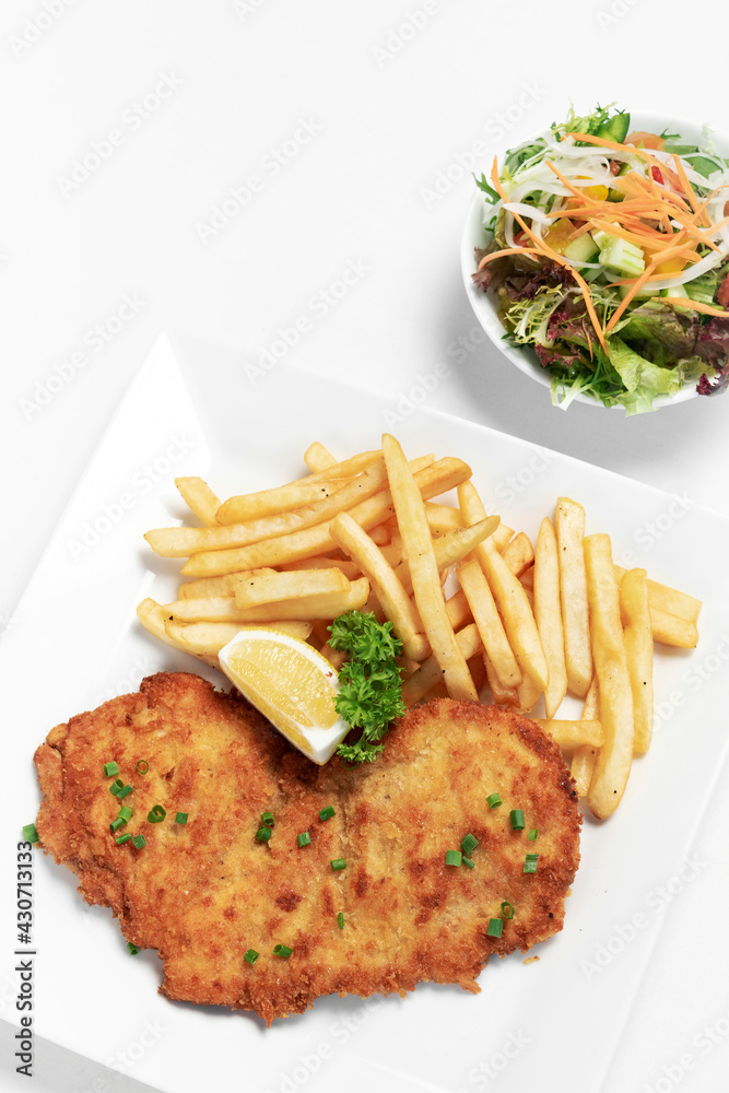 german breaded pork schnitzel with french fries german breaded pork schnitzel with french fries