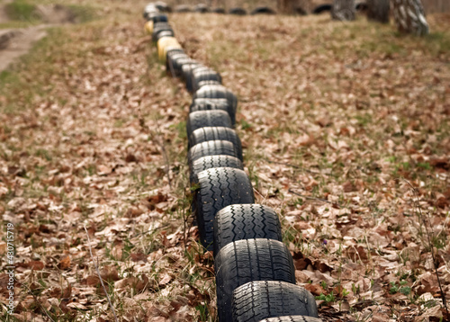 A small fence made of old tires dug into the ground.