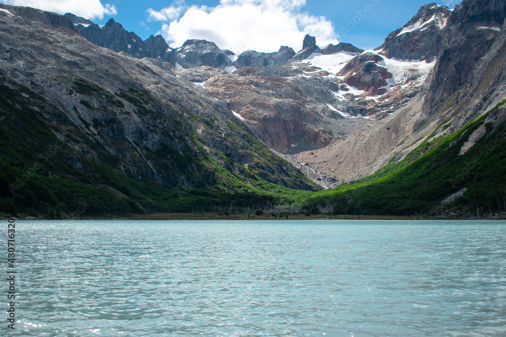 beautiful view of emerald lagoon with mountains in the background beautiful view of emerald lagoon with mountains in the background
