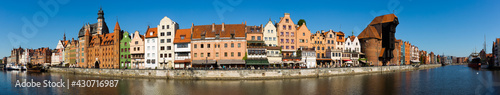 Panoramic view of Motlawa river embankment in Gdansk in sunny spring day, Poland. photo