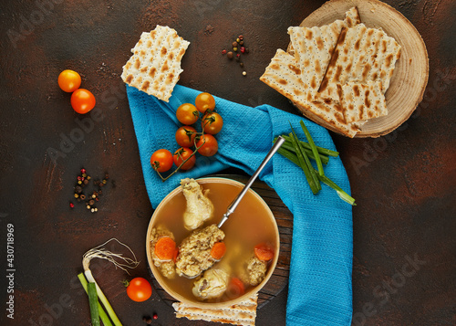 Soup with matzo dumplings and chicken with carrots and tomatoes. Healthy Food for Passover photo