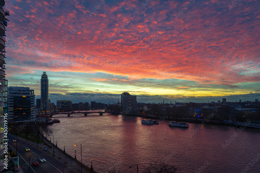 Burning sky at sunset time over Thames river in London, UK