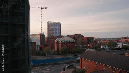 A timelapse at golden hour in England's second city, Birmingham. Looking over St Chad's Queensway you can see a crane and a building under construction in the distance. photo