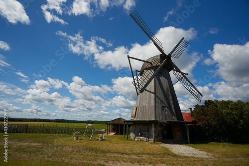 old wooden wind-mill on a colorful summer day