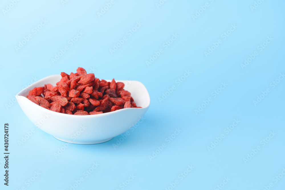 Bowl with dried goji berries on color background Bowl with dried goji berries on color background