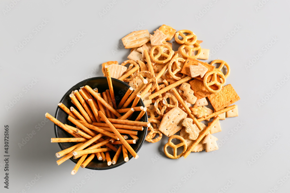 Bowl with tasty different crackers on light background Bowl with tasty different crackers on light background
