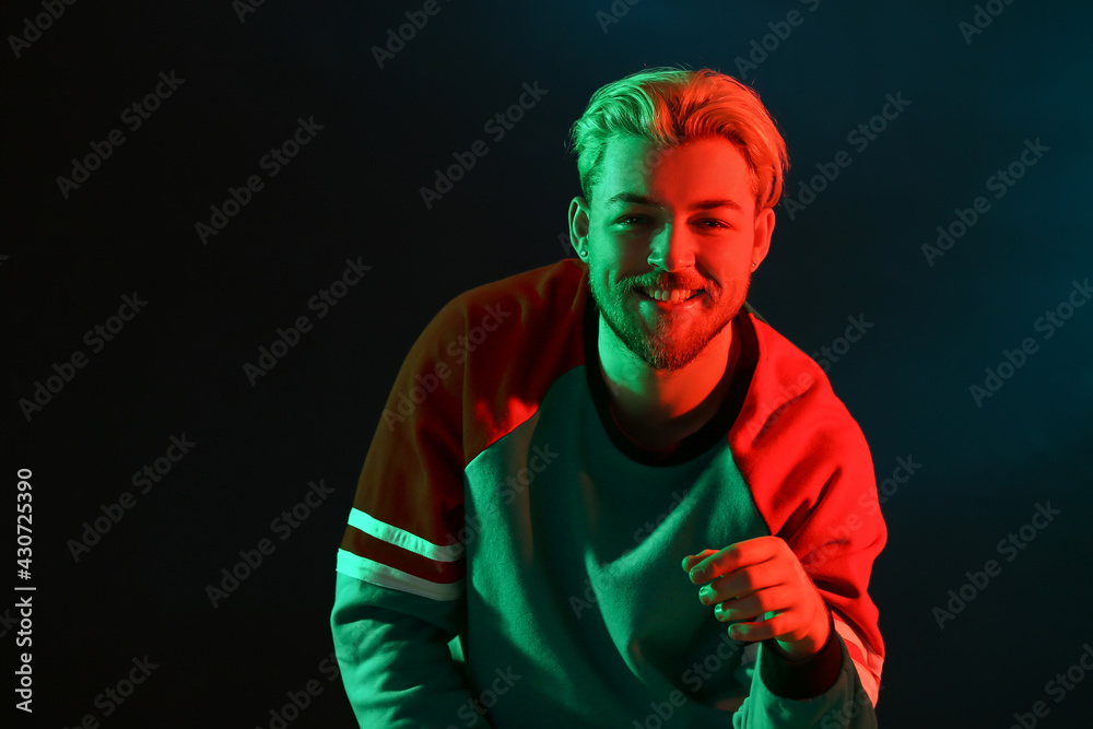 Toned portrait of handsome young man on dark background Toned portrait of handsome young man on dark background