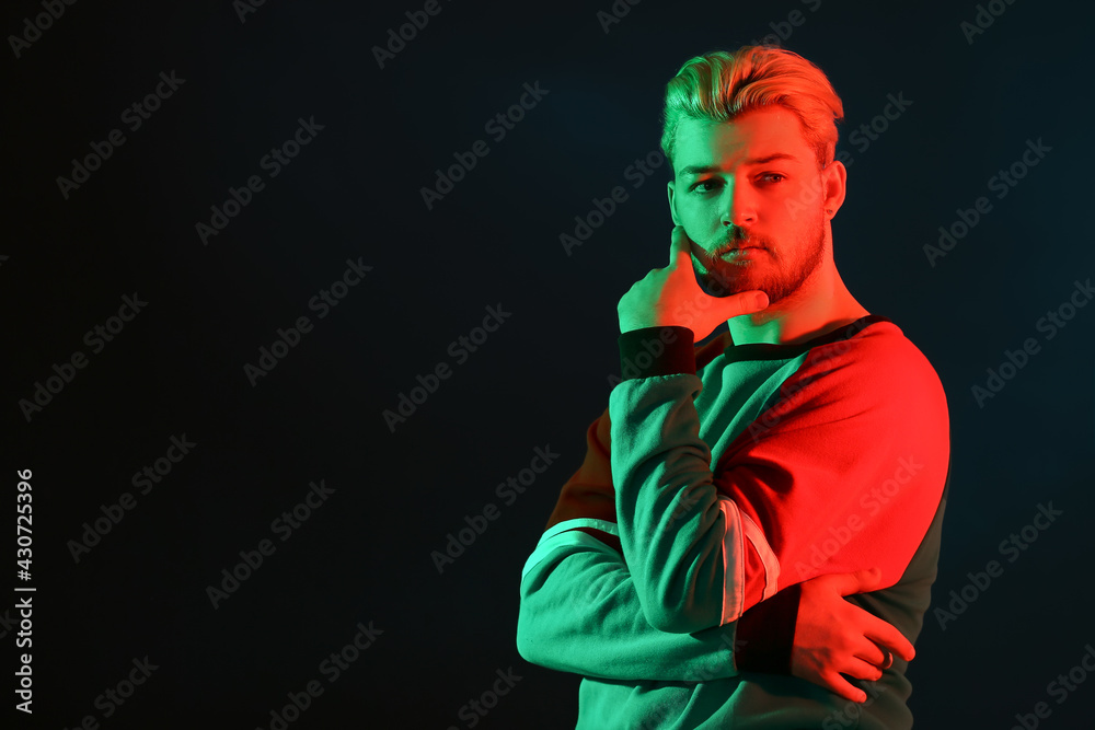 Toned portrait of handsome young man on dark background Toned portrait of handsome young man on dark background