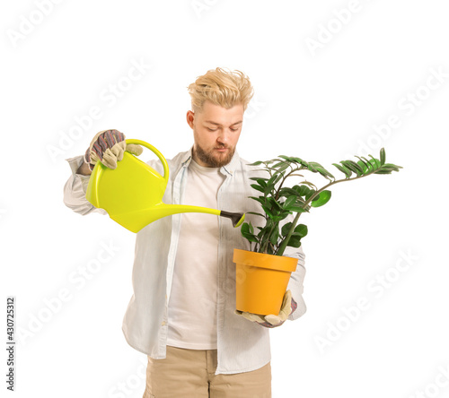 Young male gardener on whit...