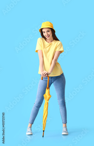 Stylish young woman with um...