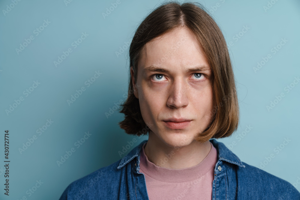 Fototapeta premium Young european man frowning and looking upward
