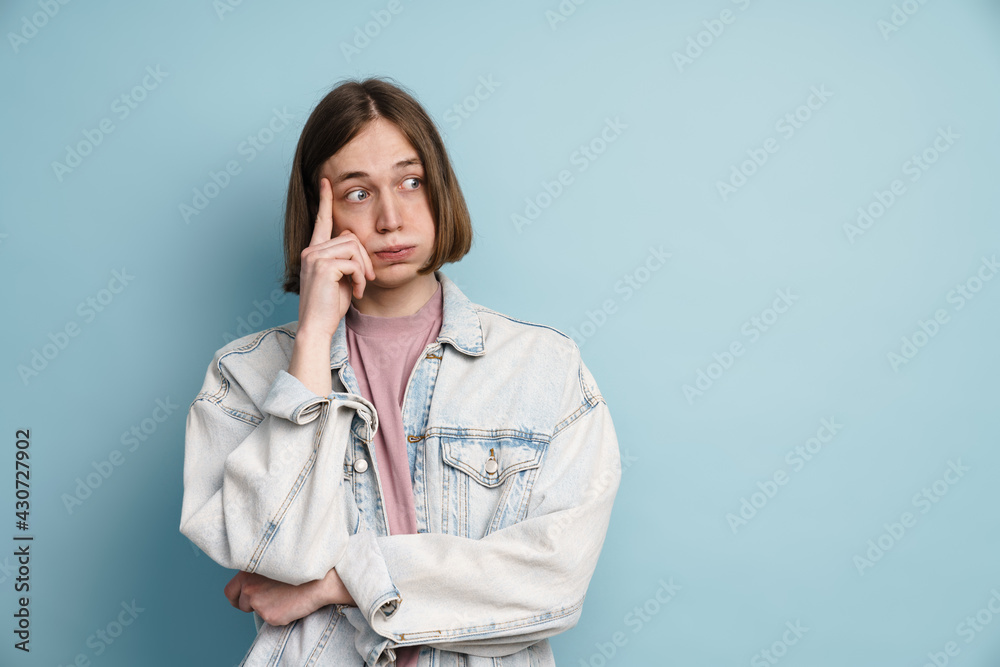 Young european man expressing surprise and looking aside Young european man expressing surprise and looking aside