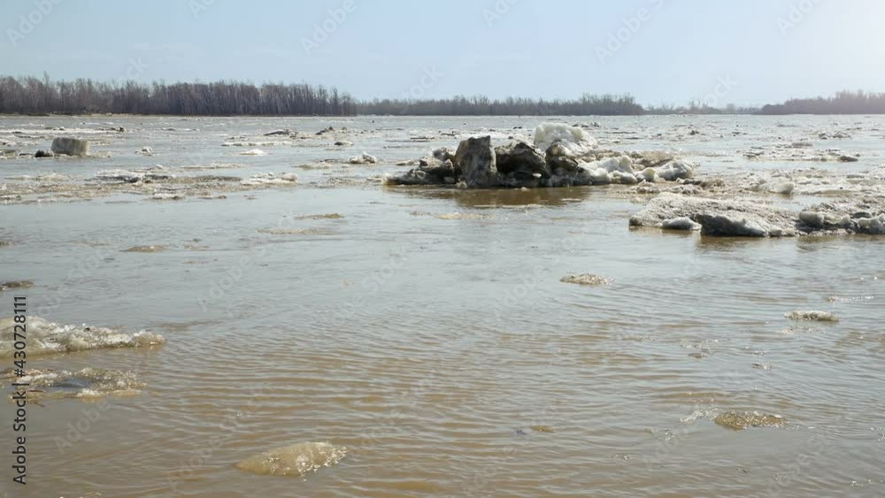 Spring drifting of ice on the river. Floating gray ice floes. Russia. Altai Territory. Ob River. 4K video. Spring drifting of ice on the river. Floating gray ice floes. Russia. Altai Territory. Ob River. 4K video.