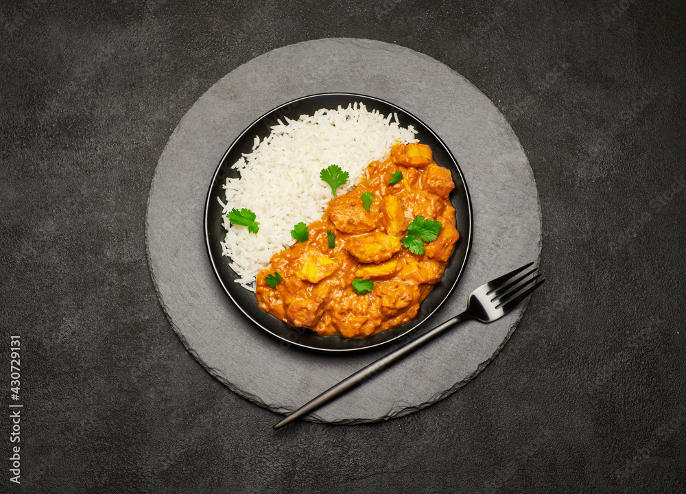 Plate of Traditional Chicken Curry and rice on stone serving board Plate of Traditional Chicken Curry and rice on stone serving board