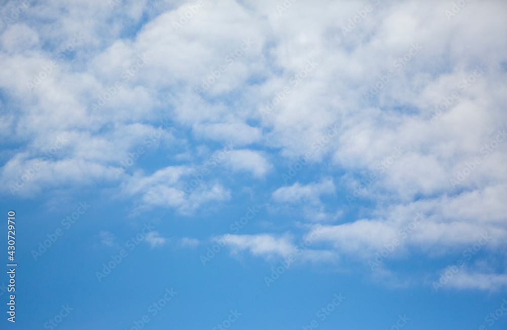 Blue sky with clouds. Background with copy space. Calm image.