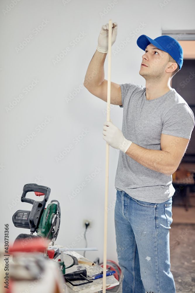 Young adult man working on a DIY budget renovation of his new home apartment. Young adult man working on a DIY budget renovation of his new home apartment.