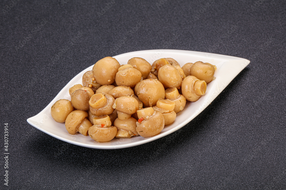 Pickled champignons in the bowl Pickled champignons in the bowl