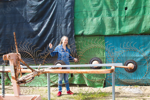 woman farmer is checking the ploughs before putting them on the tractor to do the farms chores.