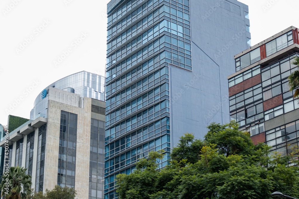 Office and apartment buildings with cloudy sky as background