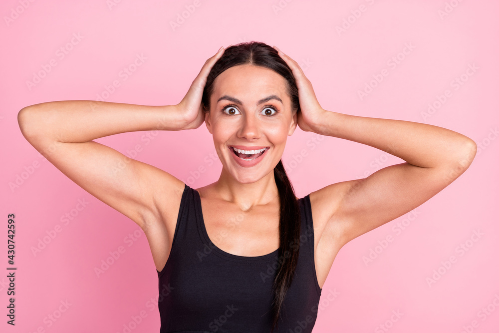Photo of amazed excited young woman hold hands head sale news isolated on pastel pink color background Photo of amazed excited young woman hold hands head sale news isolated on pastel pink color background