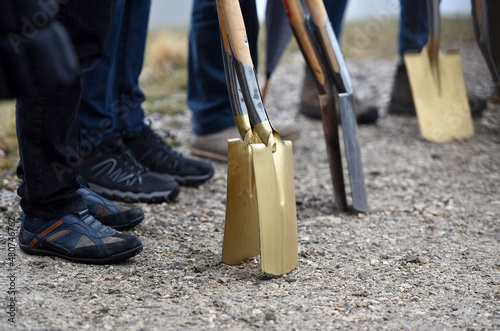 A golden spade at a groundbreaking ceremony for a building photo