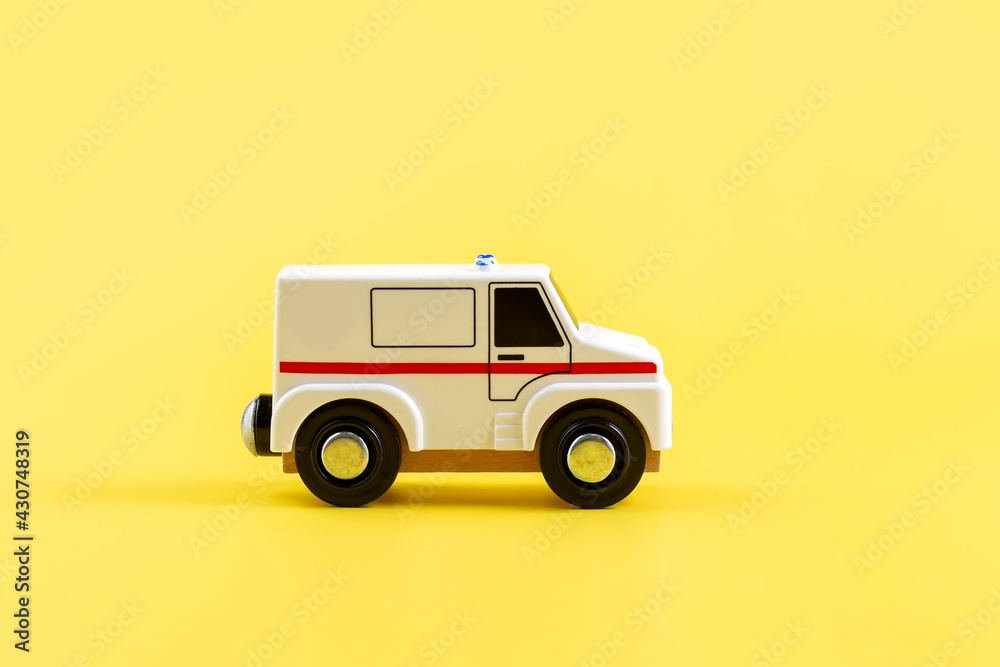 Children's toy, car on a yellow background. Ambulance. Concept. Isolate. Copy space. Children's toy, car on a yellow background. Ambulance. Concept. Isolate. Copy space.