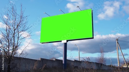 Green screen. Billboard over blue sky with clouds.