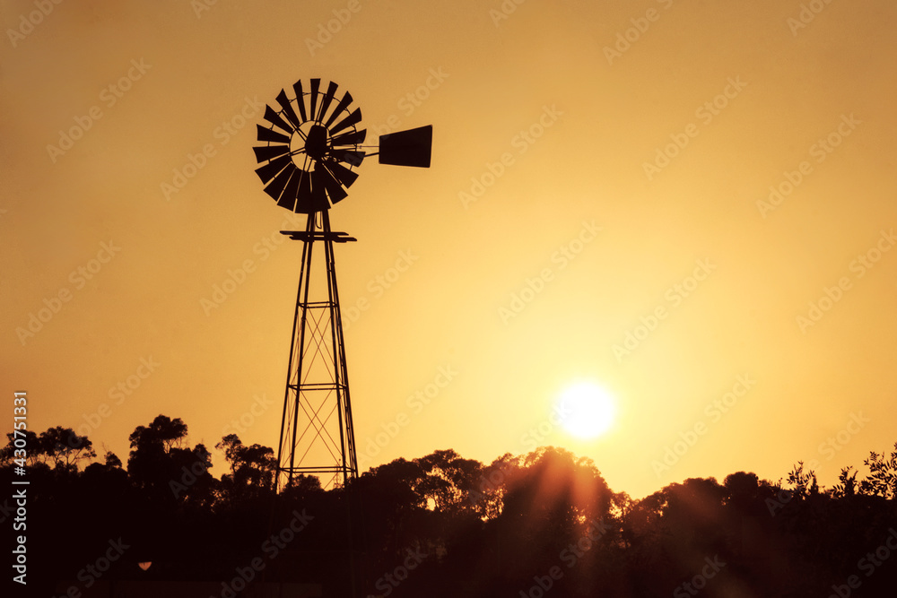 Silhouette of a windmill against the sunset Silhouette of a windmill against the sunset