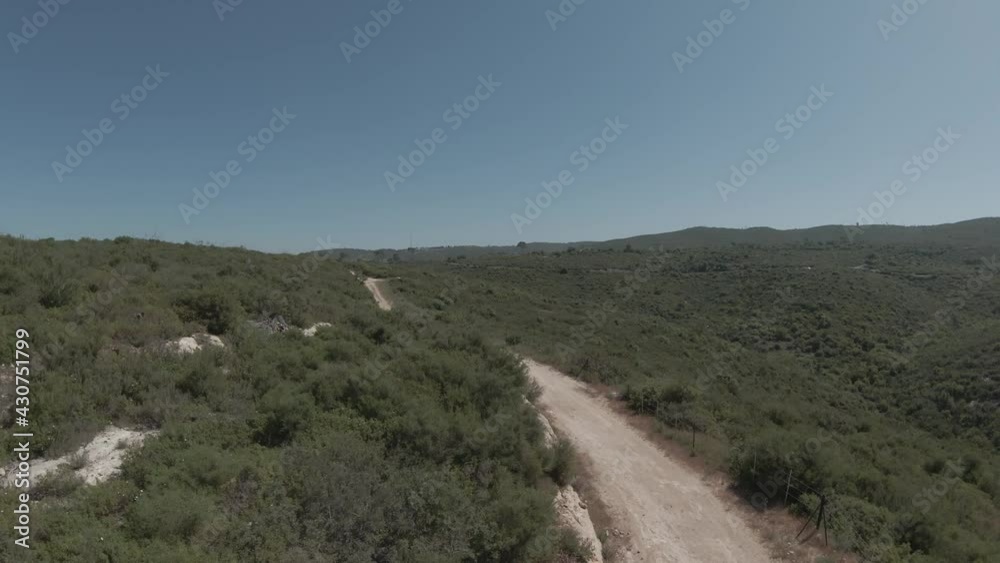 FPV drone low altitude fast flight over forest mountain landscape with horizon shifting a the drone banks. FPV drone low altitude fast flight over forest mountain landscape with horizon shifting a the drone banks.