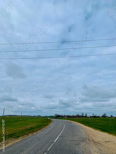Empty country road on a cloudy day with thick clouds
