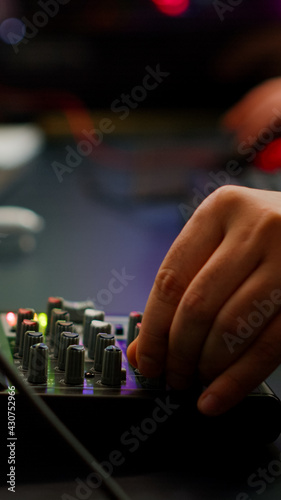 Close up of professional keyboard with RGB lighting streaming at chat. Player using powerful gaming computer in home studio of esport video game typing at keypad playing space shooter videogame.