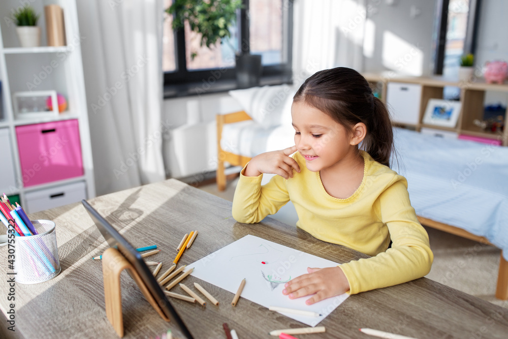 childhood, creativity and art concept - close up of little girl with coloring pencils drawing witch on paper at home childhood, creativity and art concept - close up of little girl with coloring pencils drawing witch on paper at home