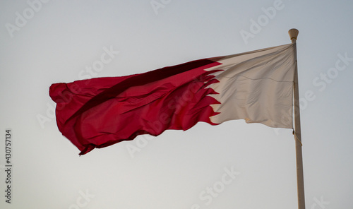 National flag of Qatar flying high. qatar flag. selective focus photo