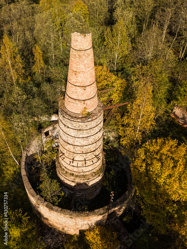 Abandoned lime kiln tower in sunny autumn day, Latvia. photo