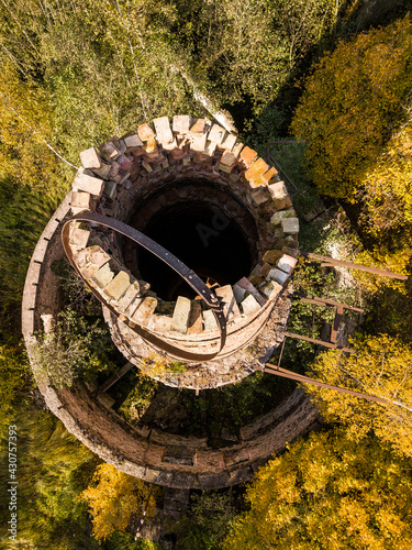 Abandoned lime kiln tower in sunny autumn day, Latvia. photo