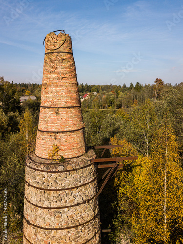 Abandoned lime kiln tower in sunny autumn day, Latvia. photo