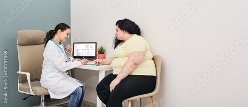 Dietitian consultation. Woman visits nutritionist for treatment obesity photo