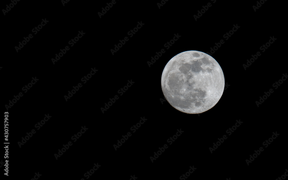 Full moon over dark black sky at night. Selective focus Full moon over dark black sky at night. Selective focus