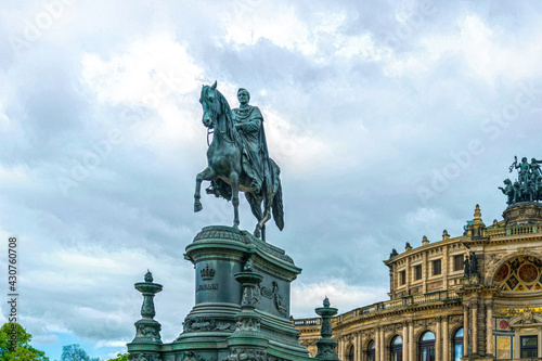 Dresden, Germany - May 02 2019: statue of the Saxon King Johann at the facade of the Semper Opera, and the royal palace-residence, sculptor - Johannes Schilling, installed in 1889 on the Theaterplatz