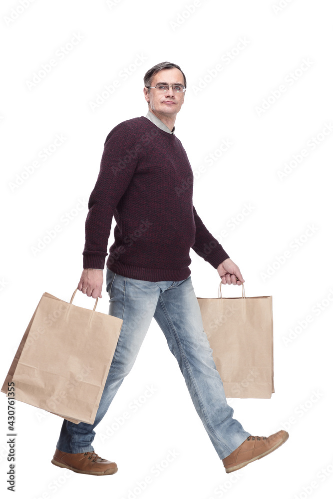full-length. casual man with shopping bags. isolated on a white full-length. casual man with shopping bags. isolated on a white