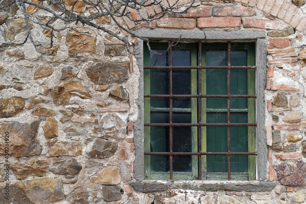 window with broken glass of old abandoned and dilapidated stone house in the Tuscan countryside in Italy window with broken glass of old abandoned and dilapidated stone house in the Tuscan countryside in Italy