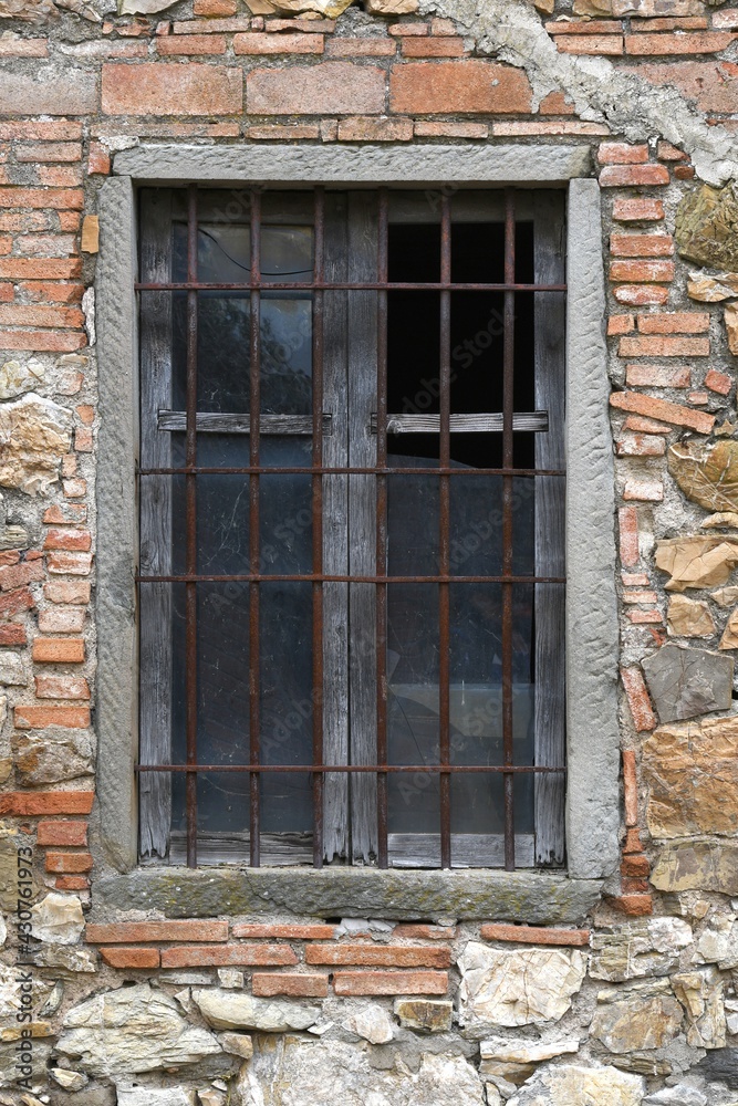 window with broken glass of old abandoned and dilapidated stone house in the Tuscan countryside in Italy window with broken glass of old abandoned and dilapidated stone house in the Tuscan countryside in Italy