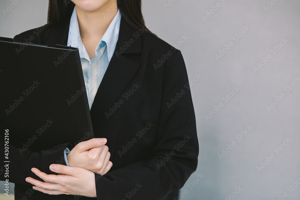Close up young businesswomen holding clipboard in office Close up young businesswomen holding clipboard in office