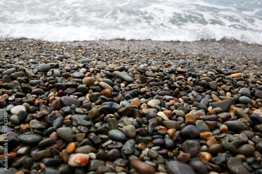 wet gray pebbles on the seashore. great background for design